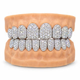 Fully iced silver moissanite grillz covering upper and lower teeth, front view