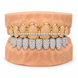 Gold open face grillz outlining the upper teeth with an iced stone bar, paired with a fully iced silver lower set, front view