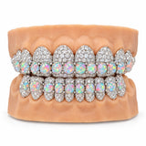 Silver moissanite grillz with a double row of round opal cabochons across upper and lower teeth, front view
