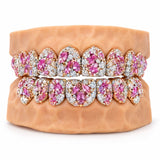 Rose gold moissanite grillz with pink marquise cut stones clustered across every tooth, front view