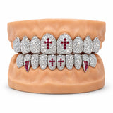 Iced silver moissanite grillz with red ruby crosses on the front teeth and red fangs, front view