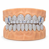 Iced silver moissanite grillz with a horizontal tennis bar of large round stones and blue accent canines, front view