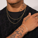 Moissanite Micro Tennis Chain in 18k vermeil, worn by a model with tattoos.