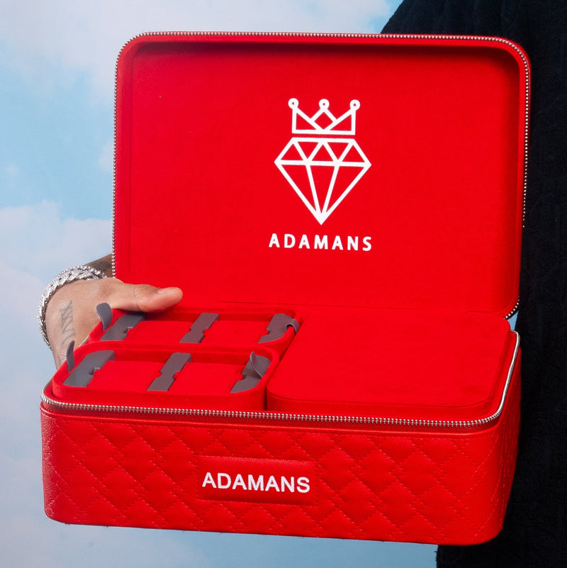 Red leather travel jewellery case with Adamans logo, featuring stackable trays and premium craftsmanship.